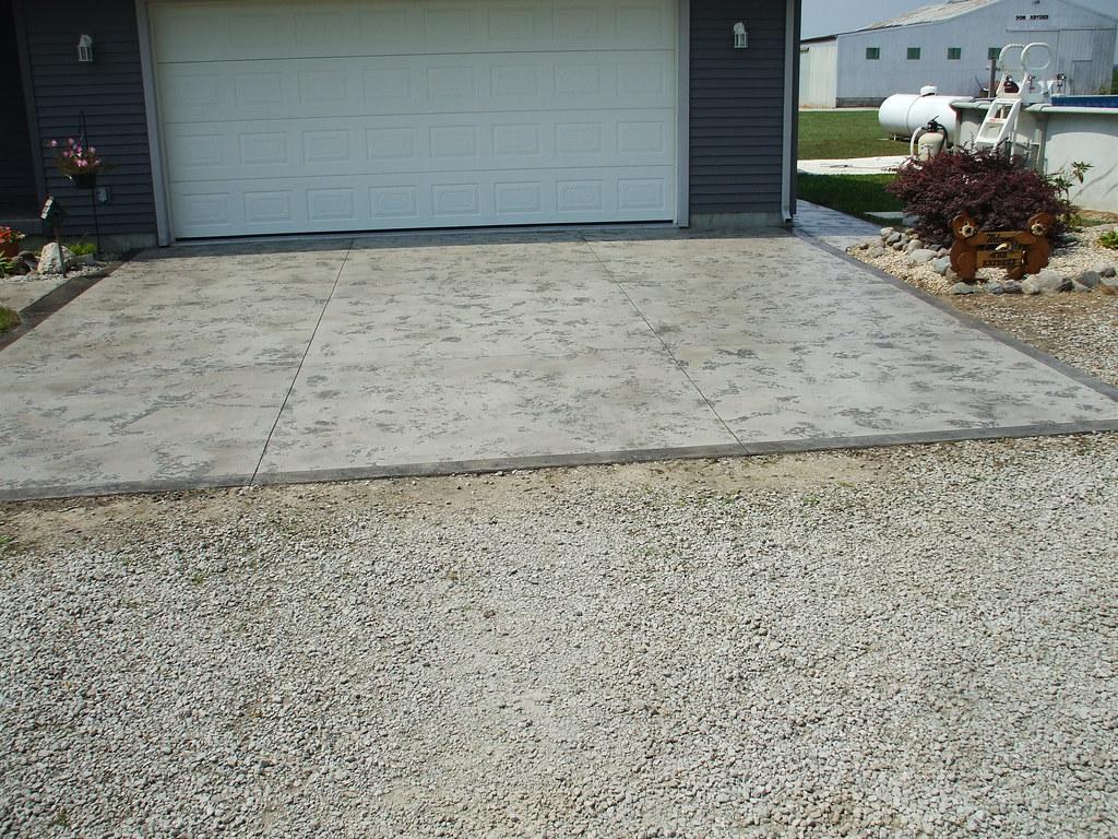 Finished concrete driveway in front of a home's garage