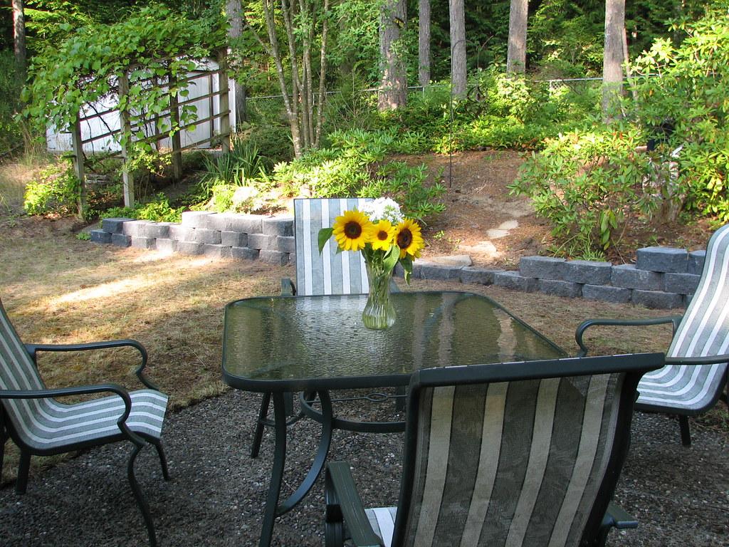 Block retaining wall terracing a wooded backyard